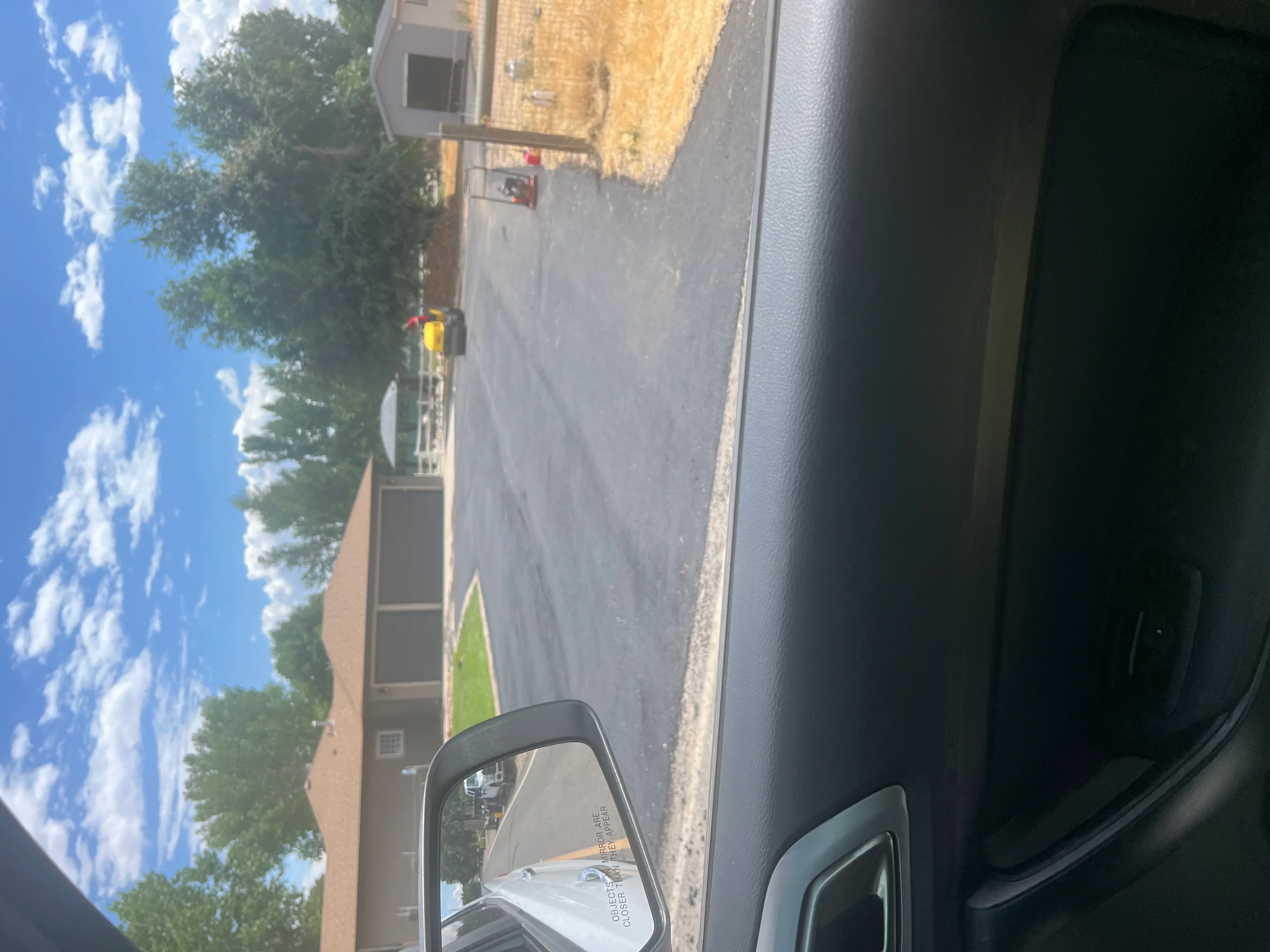 Newly paved residential asphalt driveway with dark surface and clean edges