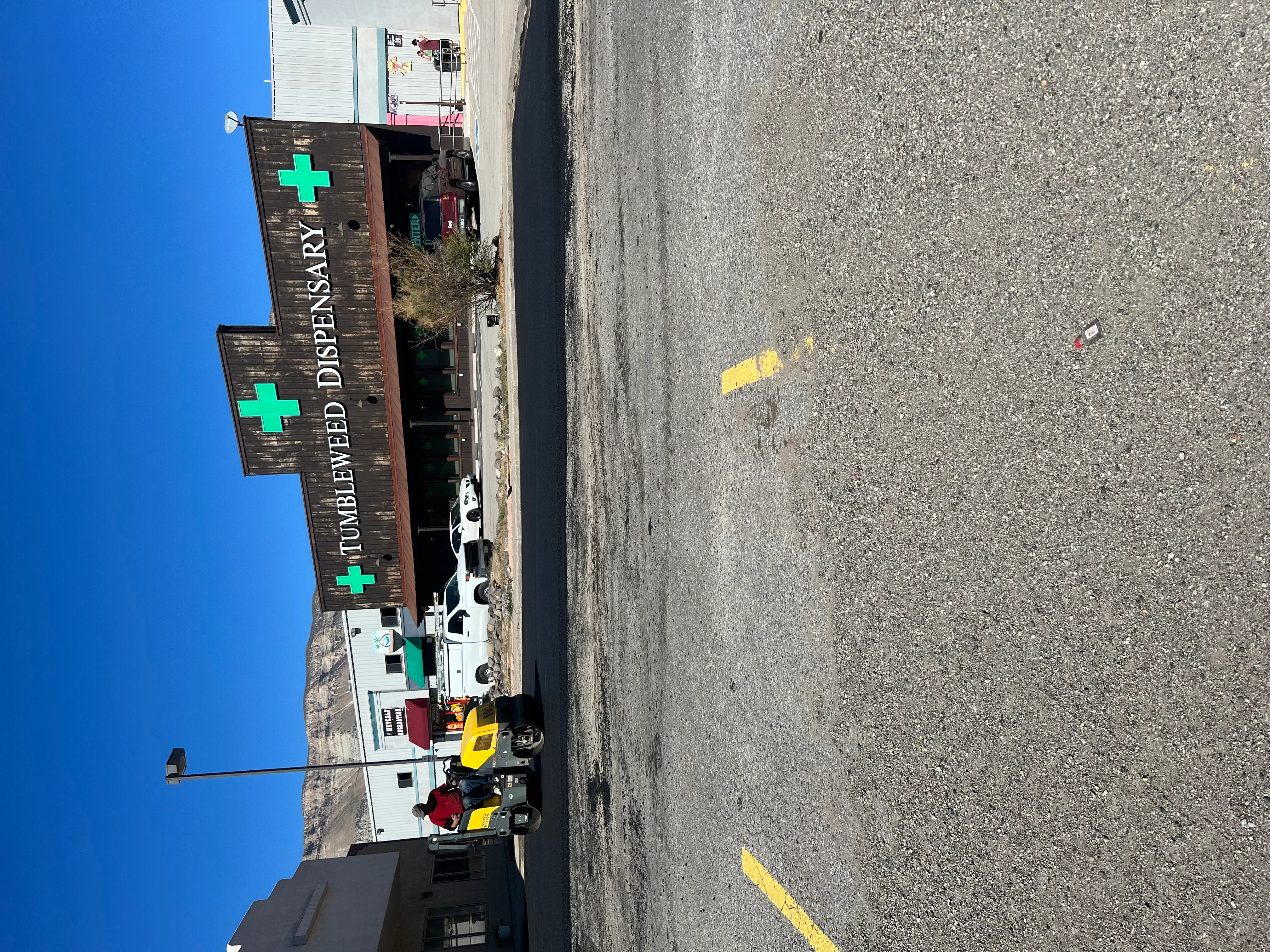 Yellow parking lot striping on asphalt with clear space markings and directional lines